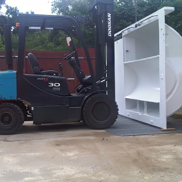 Forklift lifting and positioning heavy equipment as part of a UK lift and shift service