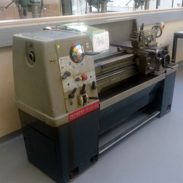 Specialist lifting team moving a machine tool with controlled handling equipment