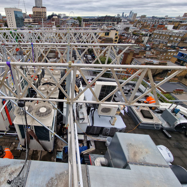 AHU raised on scaffold runway beam with live services still connected