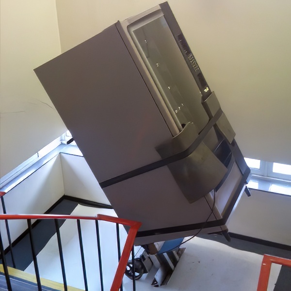 Vending machine being moved over steps using controlled lift and shift methods